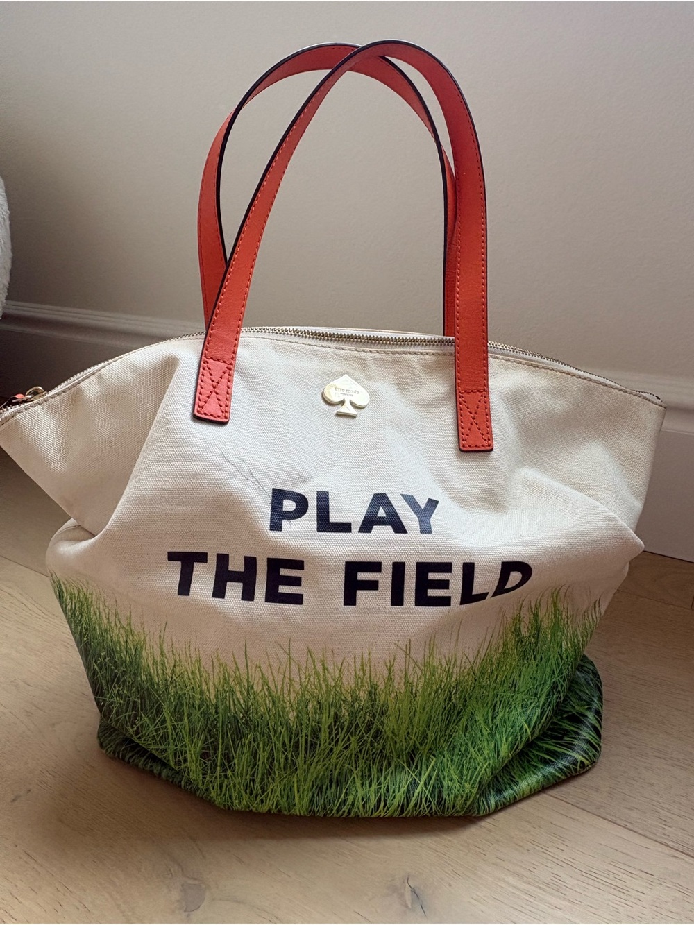 kate spade canvas tote in cream with orange straps and green grass print